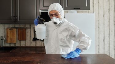 Photo Of Person Disinfecting The Table